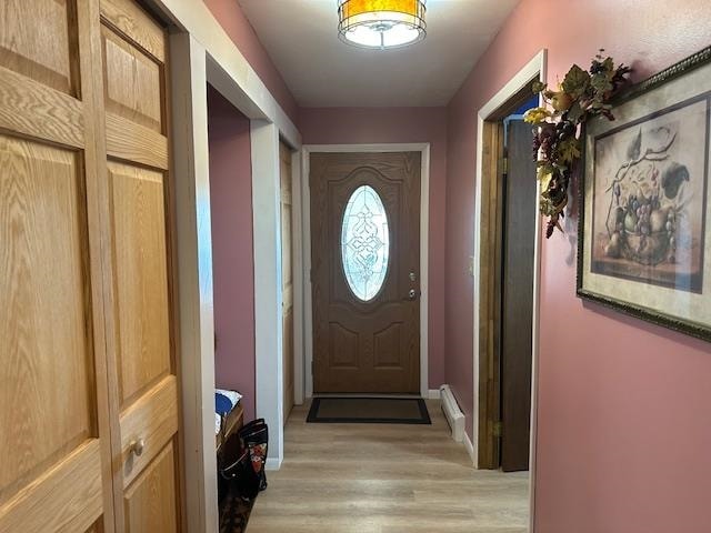 entryway with light hardwood / wood-style flooring and a baseboard radiator