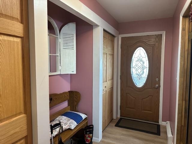 entryway featuring a baseboard radiator and light hardwood / wood-style floors