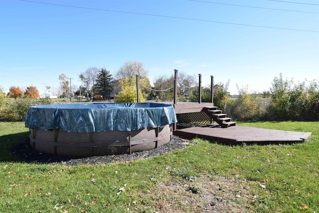 view of pool featuring a deck and a yard