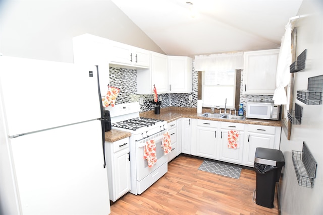 kitchen with lofted ceiling, white cabinets, light hardwood / wood-style floors, sink, and white appliances