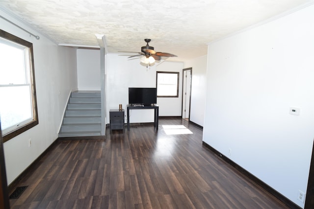 unfurnished living room featuring ceiling fan, a textured ceiling, and dark hardwood / wood-style flooring