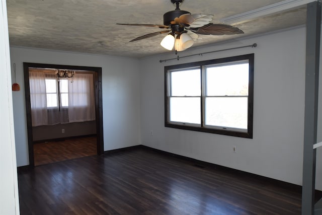 empty room featuring dark hardwood / wood-style floors, a textured ceiling, plenty of natural light, and ceiling fan