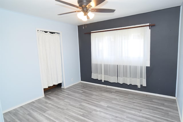 spare room featuring ceiling fan and light hardwood / wood-style flooring