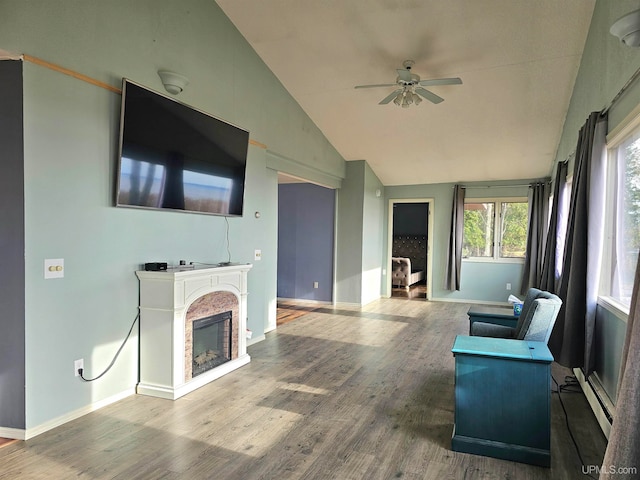 unfurnished living room with hardwood / wood-style floors, ceiling fan, lofted ceiling, and a baseboard heating unit