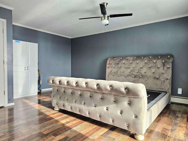 bedroom with dark hardwood / wood-style floors, ceiling fan, and crown molding