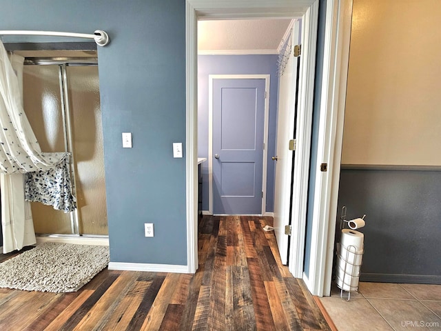 hall featuring a textured ceiling, dark hardwood / wood-style floors, and crown molding