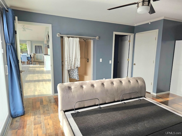 bedroom featuring ceiling fan, wood-type flooring, and ornamental molding