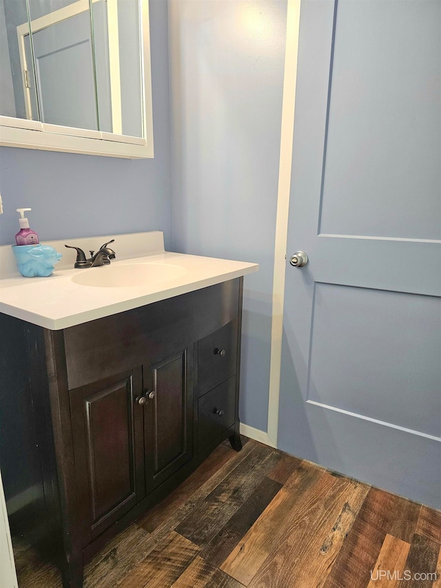 bathroom with vanity and wood-type flooring