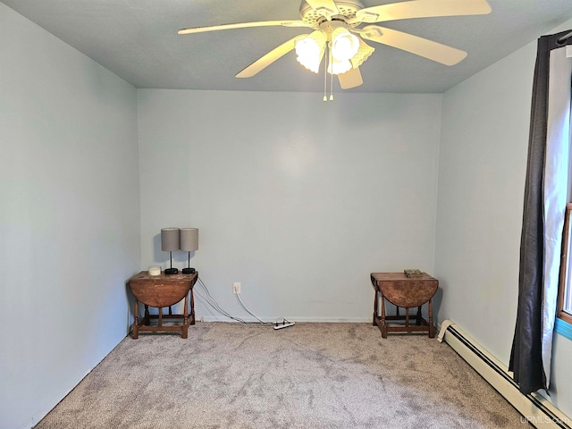 carpeted empty room with a baseboard radiator and ceiling fan