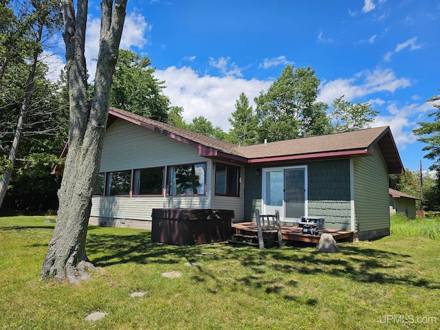 rear view of property with a lawn and a wooden deck