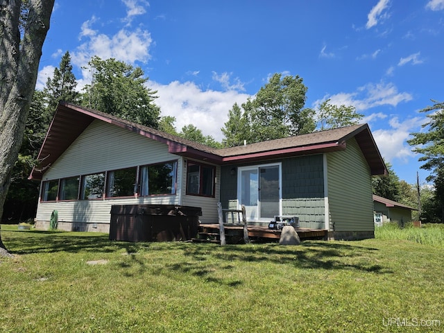 back of house with a lawn