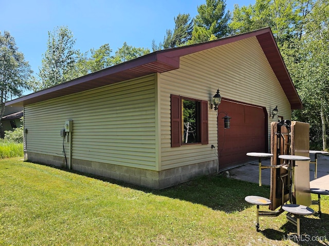 view of side of home with a yard and a garage