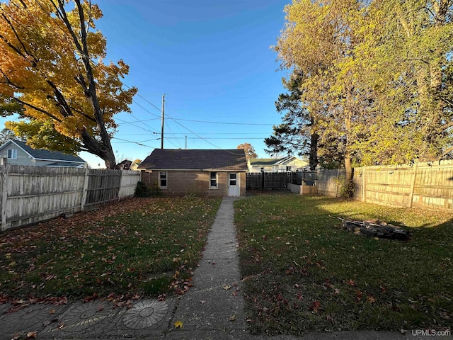 rear view of property featuring a lawn