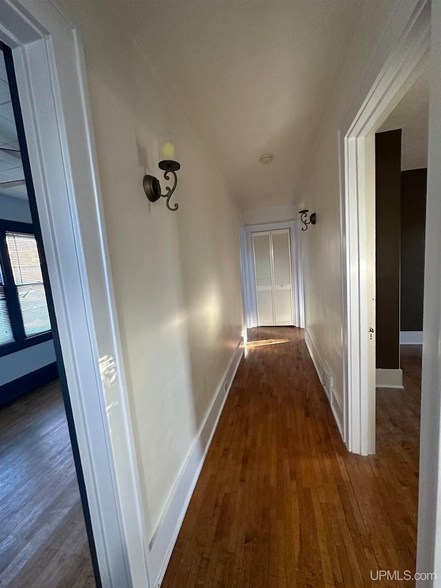 hall with dark hardwood / wood-style flooring