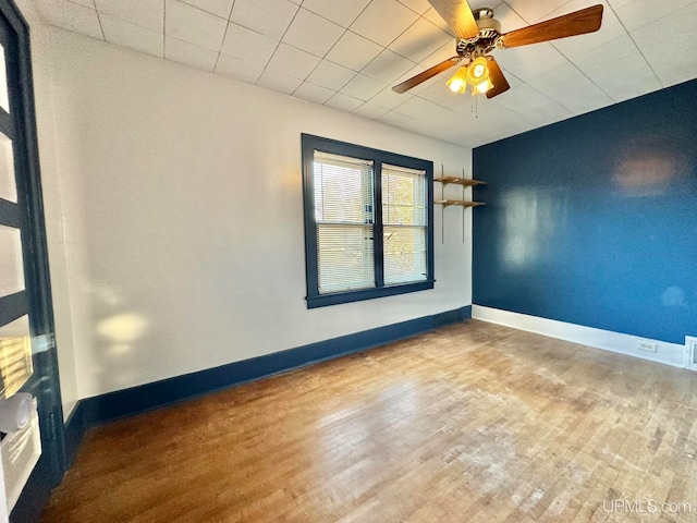 spare room with ceiling fan and wood-type flooring