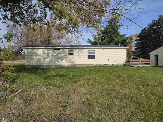 back of house with a lawn