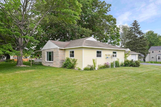 view of side of property with a lawn