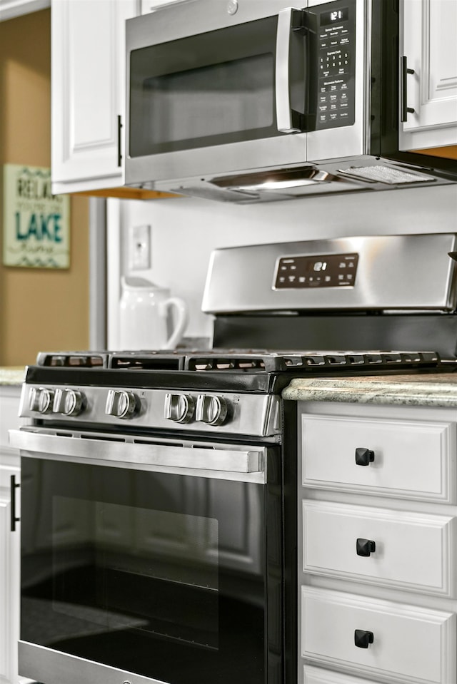 kitchen featuring appliances with stainless steel finishes and white cabinets