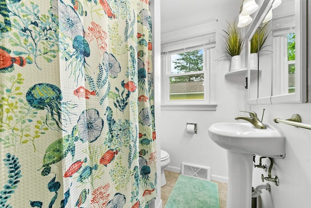 bathroom featuring toilet and tile patterned floors