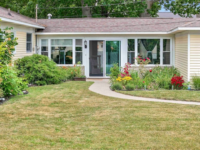 doorway to property with a yard