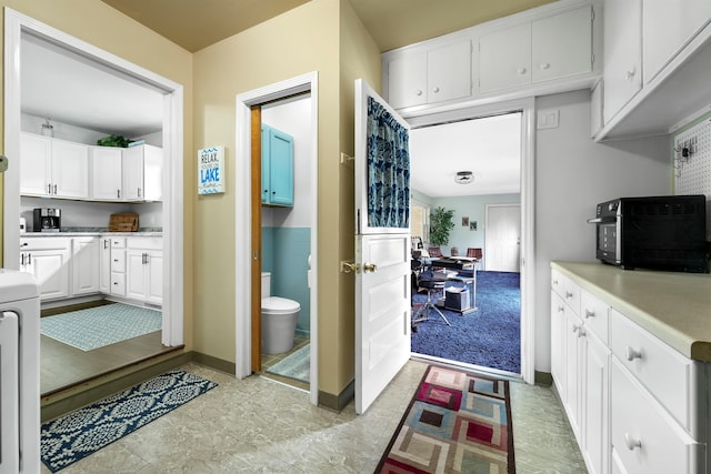 kitchen featuring white cabinets and light tile patterned floors