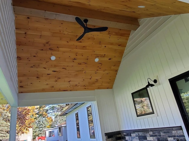 exterior details featuring ceiling fan, wood ceiling, and wood walls