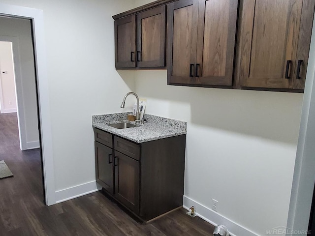 kitchen featuring dark hardwood / wood-style floors, sink, and dark brown cabinets