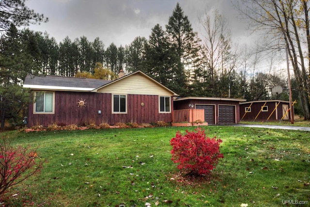 single story home with a front yard and a garage