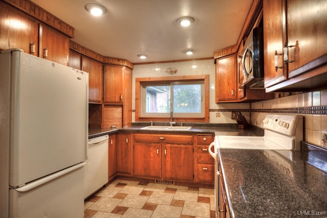 kitchen with decorative backsplash, sink, and white appliances