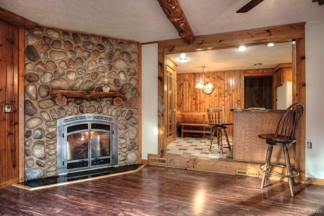 living room with hardwood / wood-style floors, a textured ceiling, and a chandelier