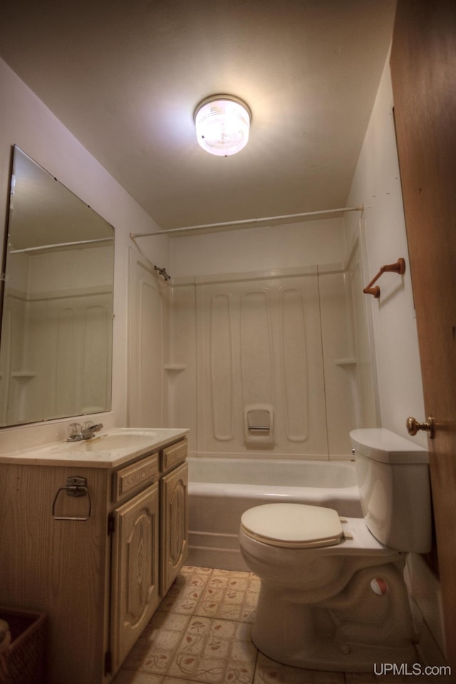 bathroom with toilet, vanity, and shower / bathing tub combination