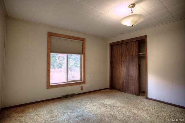 unfurnished bedroom with carpet flooring and a closet