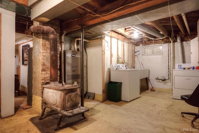 basement featuring washing machine and dryer and heating unit