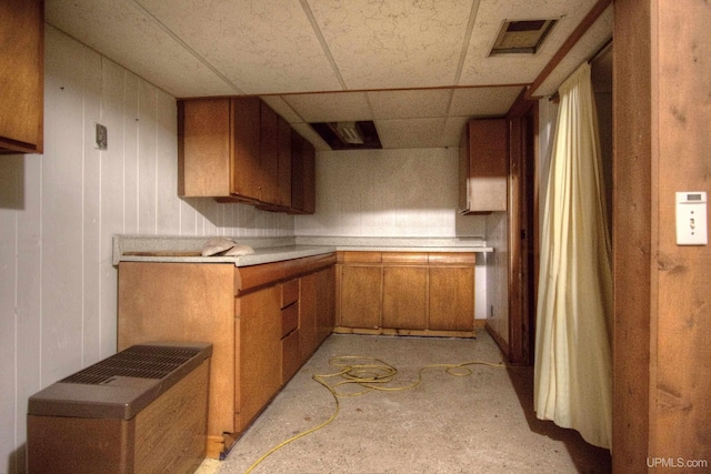 kitchen with light countertops, visible vents, brown cabinets, and a paneled ceiling
