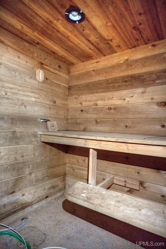 view of sauna / steam room featuring wood ceiling and wooden walls