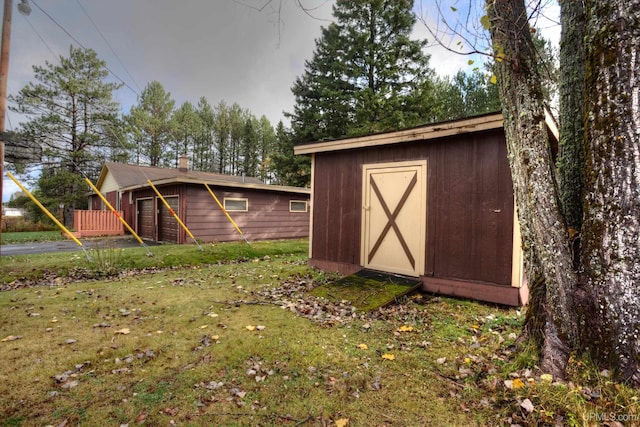 view of outbuilding featuring a yard