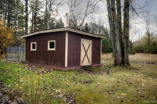 view of outbuilding featuring a lawn