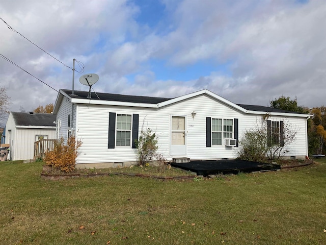 rear view of house featuring a patio, cooling unit, and a yard