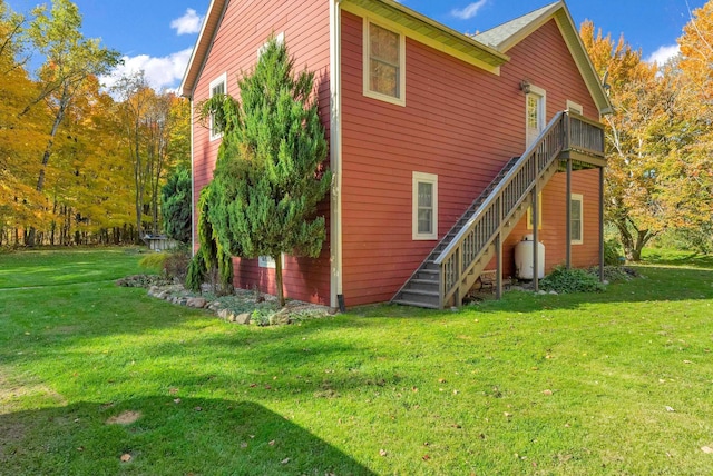 rear view of house featuring a lawn