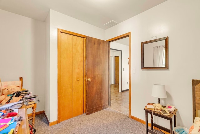 interior space featuring light carpet and a closet