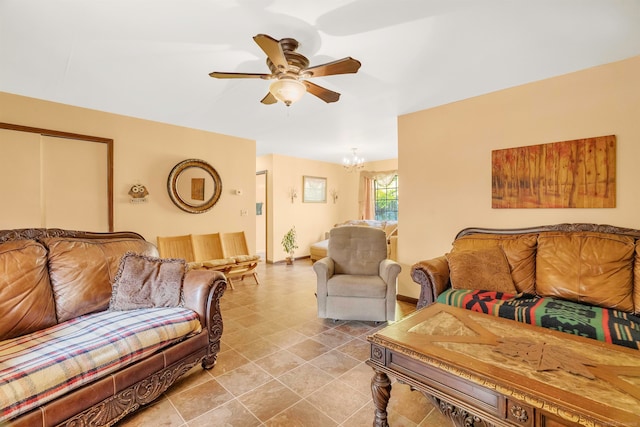 living room with ceiling fan with notable chandelier