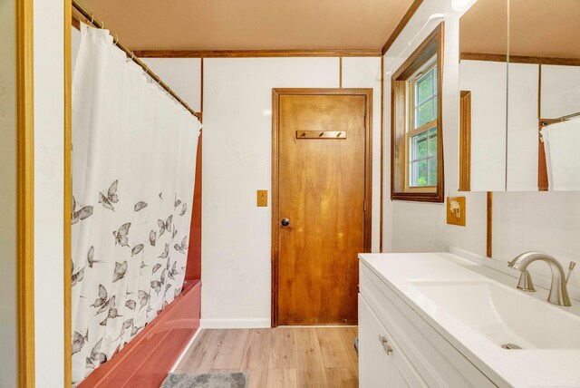 bathroom with vanity, crown molding, shower / bath combo, and hardwood / wood-style floors