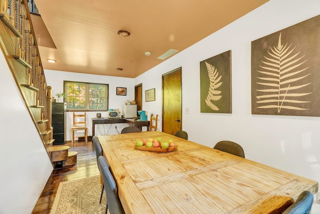 dining space with dark wood-type flooring