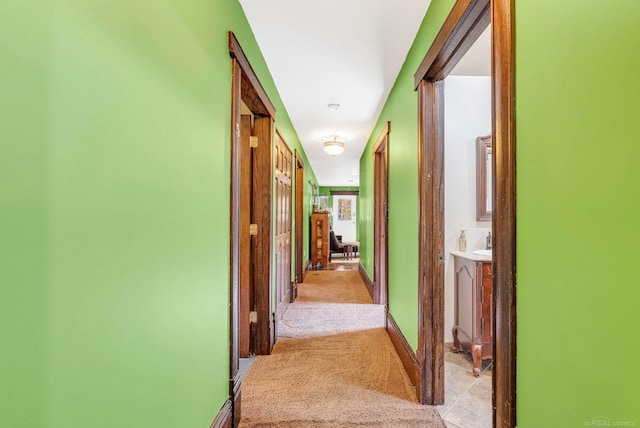 hallway featuring light carpet