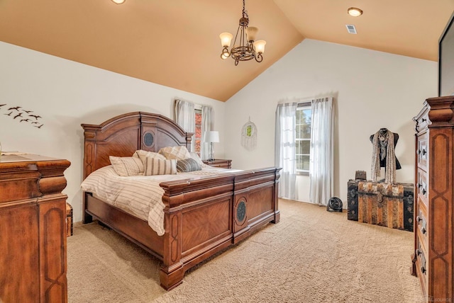 carpeted bedroom featuring a chandelier and vaulted ceiling