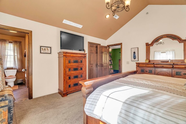 bedroom featuring a closet, a notable chandelier, light colored carpet, ensuite bathroom, and high vaulted ceiling