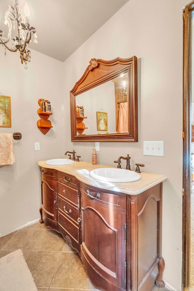 bathroom with vanity, a notable chandelier, and tile patterned flooring