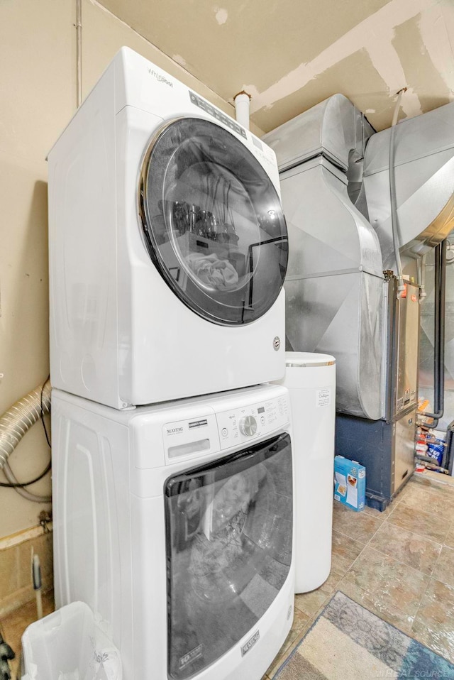 washroom featuring stacked washer / dryer