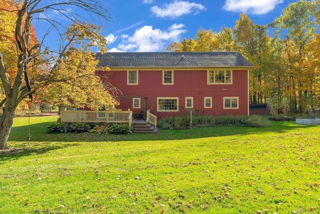 back of property with a yard and a deck