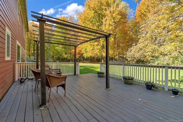 deck featuring a lawn and a pergola